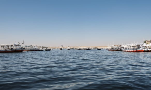 Aswan, Egypt - 5 November 2024: Many docked tour boats and ferries by the Old Aswan dam used to transport tourists to Philae Temple