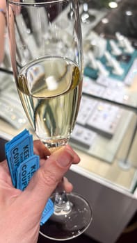 A toast with sparkling wine and raffle tickets indicates a festive event. The elegant backdrop suggests a celebration filled with joy, socializing, and memorable moments.