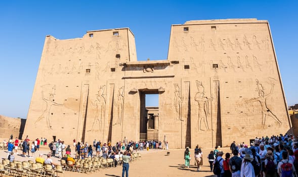 Edfu, Egypt - 6 November 2024: Many tourists walking towards the massive temple in Edfu dedicated to Horus and Hathor