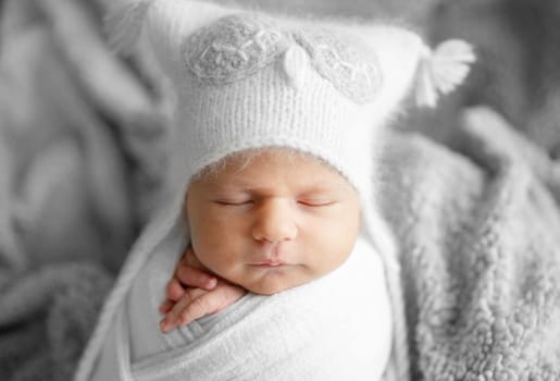 Newborn Baby Sleeping In Owl Hat Studio Photo