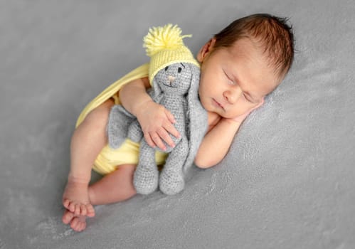 Newborn Baby Sleeping With A Smile In A Studio Photo