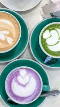 Savor these three exquisite coffee an d matcha drinks adorned with colorful latte art. Perfect for a cozy cafe setting, they offer a delightful experience for coffee lovers and social gatherings.