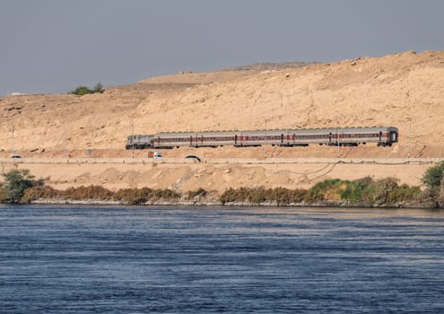 Egyptian passenger train alongside the River Nile near Aswan and heading north