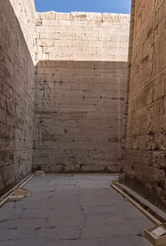 Hieroglyphics cover the walls of the corridor formed by external walls and inner sanctuary of Edfu Temple in Egypt