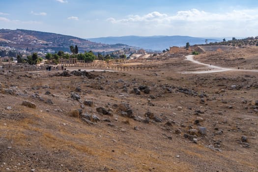 Tourists walking between monuments in Jerash, a Greco-Roman well preserved city in Jordan