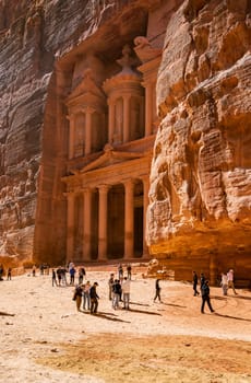 Petra, Jordan - 10 November 2024: Tourists at the carved facade of the Treasury building or Al-Khazneh in the ancient city of Petra