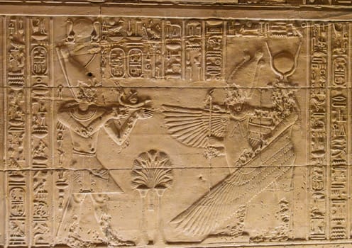Detail of the bas-relief carving of the goddess Isis spreading wings in the Philae Temple in Aswan Harbor or Reservoir in Egypt