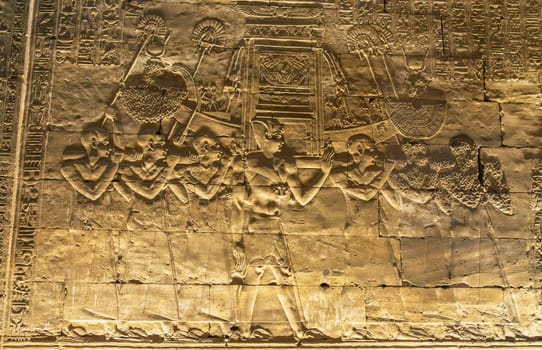 Detail of the carved images inside the temple in Edfu dedicated to Horus and Hathor showing slaves carrying funeral boat