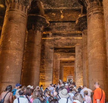 Edfu, Egypt - 6 November 2024: Many tourists moving inside the massive temple in Edfu dedicated to Horus and Hathor