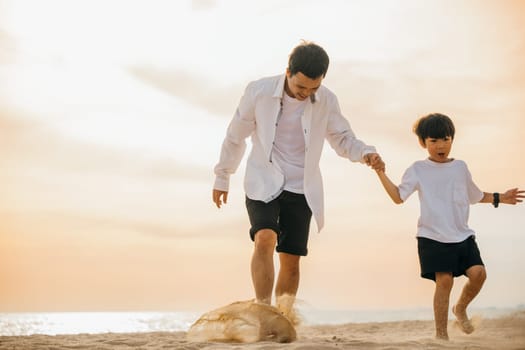 A playful scene at the beach as an Asian father runs with his son hand in hand. Laughter bonding and family togetherness captured in this joyful moment
