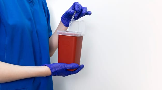 Mockup Doctor Disposes Needle, Ampule In Sharps Container. Disposal Container For Infectious Waste, Reducing Medical Waste Disposal. Small Medical Plastic Box With Sharps For Bio Hazard. Copy Space