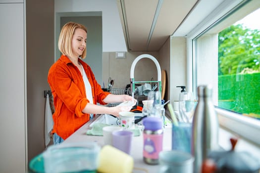 Bright kitchen filled with natural light as dishes are cleaned.