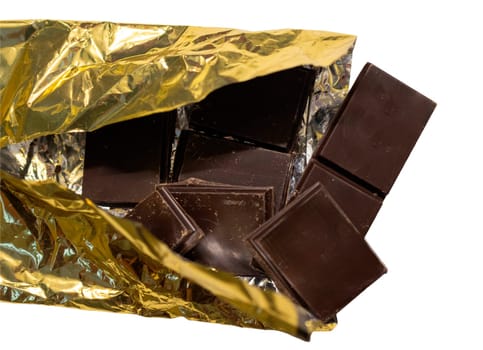 Tantalizing close-up chocolate for advertisements.Isolated dark chocolate for graphic design.Broken Gourmet Chocolate. Top View.Dark Chocolate Chunks with golden wrapper for Recipes