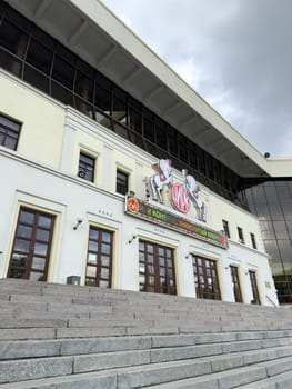 Moscow, Russia, April 25, 2025: The main entrance of Nikulin Circus on Tsvetnoy Boulevard with electronic sign advertising the clown hemed show above classic wooden doors