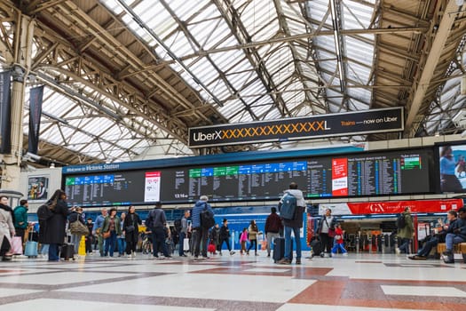 Victoria Station London featuring trains, travelers, and spacious station hall. London, UK, 6 April 2024