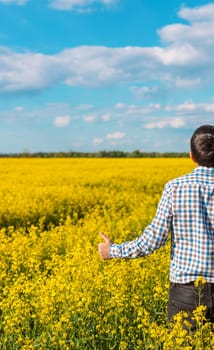 farmer in mustard field. Selective focus. nature.
