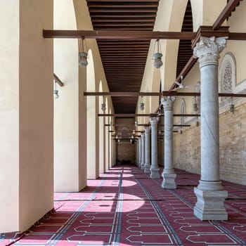 The Al-Zahir Baybars Mosque in Cairo is a testament to Egypt's profound Islamic heritage, characterized by its towering columns, arched passages, and intricately decorated prayer carpet