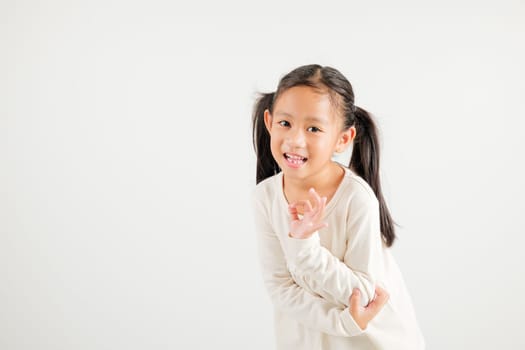 Exuberant young kid girl showcases the OK sign with an optimistic smile, conveying agreement and positivity isolated on a white background, ideal for your text customization. kindergarten child smile
