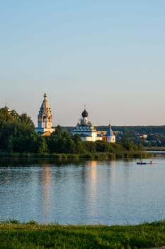 Vorsma, Nizhny Novgorod Region, Russia - 06.08.23. View of the Holy Trinity Ostrovoezersky Monastery with people on boats and SUPs.