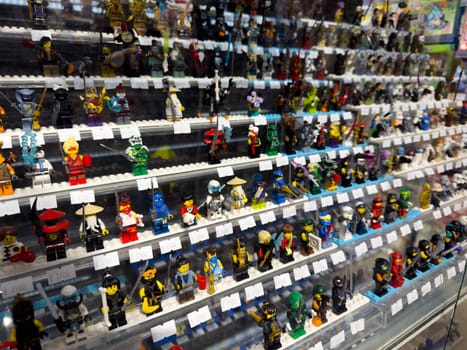 Moscow, Russia, April 25, 2025: Rows of collectible Lego mini figures displayed in Lego themed museum shop where visitors can admire and purchase rare characters from different series and eras