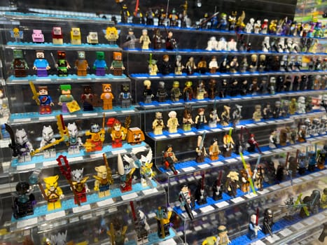 Moscow, Russia, April 25, 2025: Large variety of themed Lego minifigures on display inside Lego museum and retail corner, including characters from Minecraft, Star Wars and other popular franchises