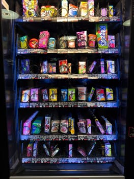 Moscow, Russia, April 25, 2025: Vending machine filled with wide variety of chewing gum packs, bubble gum and mints, offering colorful assortment and convenient access in public location