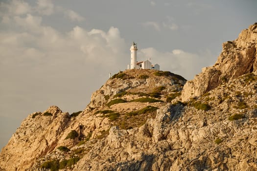 lighthouse on a high mountain at sunset. High quality photo