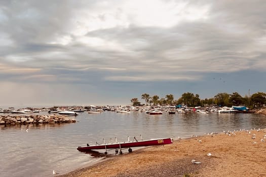 Sunrise and dramatic clouds. Early morning serene seascape in spring. Serene Spring Dawn.Witness the tranquil beauty of an early spring morning. The sun rises, casting a warm glow upon a calm sea, while dramatic clouds paint the sky, creating a breathtaking and serene seascape.