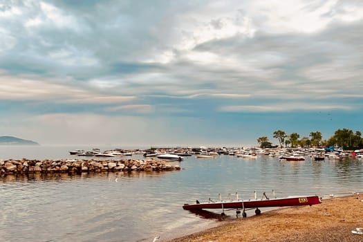 Sunrise and dramatic clouds. Early morning serene seascape in spring. Serene Spring Dawn.Witness the tranquil beauty of an early spring morning. The sun rises, casting a warm glow upon a calm sea, while dramatic clouds paint the sky, creating a breathtaking and serene seascape.