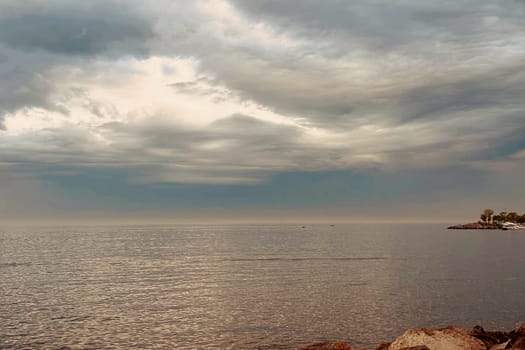 Sunrise and dramatic clouds. Early morning serene seascape in spring. Serene Spring Dawn.Witness the tranquil beauty of an early spring morning. The sun rises, casting a warm glow upon a calm sea, while dramatic clouds paint the sky, creating a breathtaking and serene seascape.