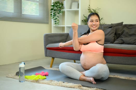 Healthy pregnancy with home exercise showing dedication to wellness and self-care.