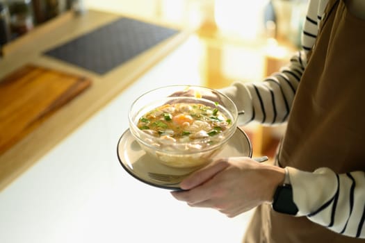 Serving nourishing soup with care and warmth.