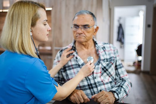 Medical professional checks an elderly man's health carefully.