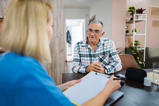 Elderly man shares stories with caregiver warmly.