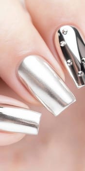 Metallic silver chrome nails closeup with rhinestone accents, vertical background, AI Generated