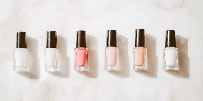 Nail polish bottles of neutral colors arranged on a marble background, AI Generated