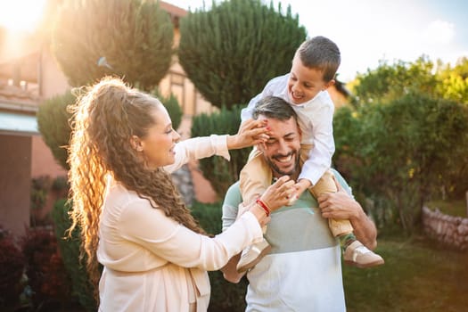 Family celebrates happiness during a sunny afternoon together.