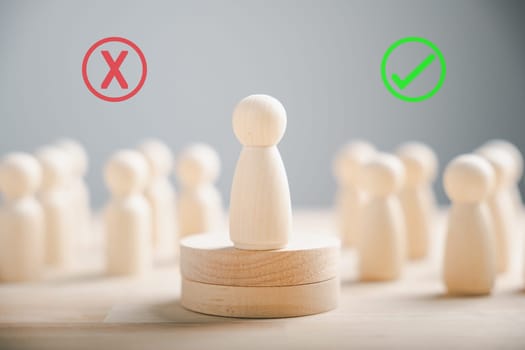 Wooden peg dolls atop a cube among others vote yes or no symbols. Reflects open-mindedness in elections involving candidates and electorates. Think With Yes Or No Choice.