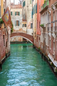 Colorful photo of quiet canal in Venice. Italy. Vertically. 