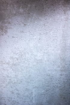 A detailed close up of a gray wall that is adorned with a multitude of small, subtle dots scattered across its surface