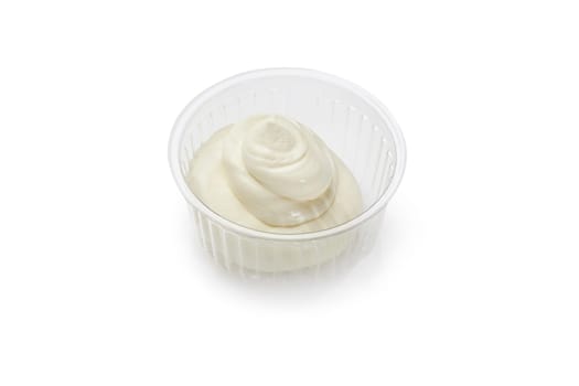 Mayonnaise sauce in a small plastic container, perfect for dipping fries or adding to sandwiches