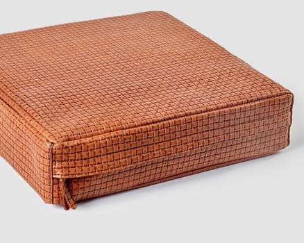 Woven leather cushion adding a touch of elegance to any interior design project