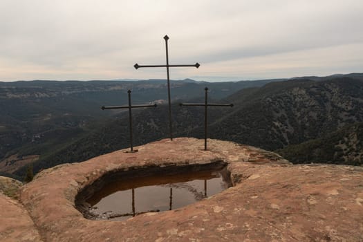 Three iron crosses on Mola d'Estat mountain peak in Tarragona