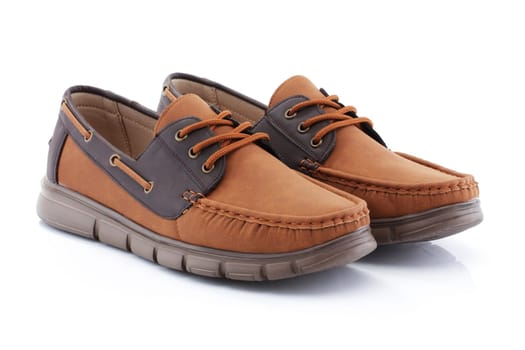 A pair of mens brown shoes loafers side view