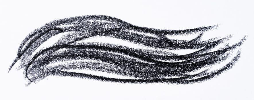 Close up of a wavy black pencil or charcoal stroke on an isolated background.