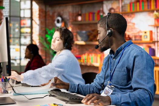 Call center agent talking in headset mic, helping customers regain access to accounts and devices. Customer center employee assisting clients needing help resetting password