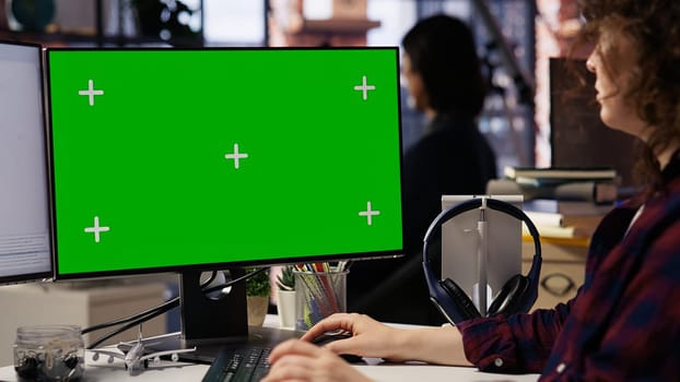 Woman coding in AI startup office using mockup PC, building scalable solutions for businesses. AI industry startup technician leveraging machine learning technology on green screen computer, camera B