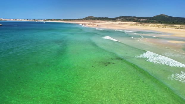 Imagine a stunning aerial view of a serene beach with vibrant turquoise waters and soft golden sands