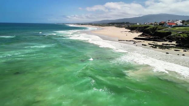 Experience stunning aerial footage of a serene beach with crystal clear waters and soft sandy shores