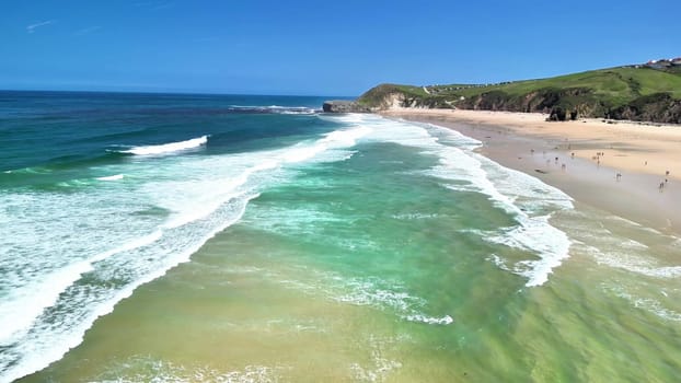 Stunning aerial shot showcasing a picturesque beach with clear turquoise water and vibrant greenery.